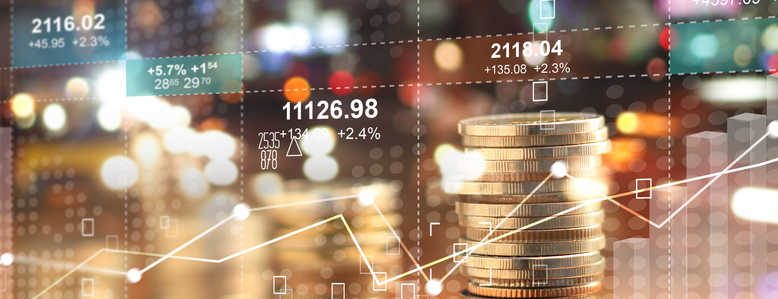 Double explosure with businesss charts of graph and rows of coins for finance at night city background.
